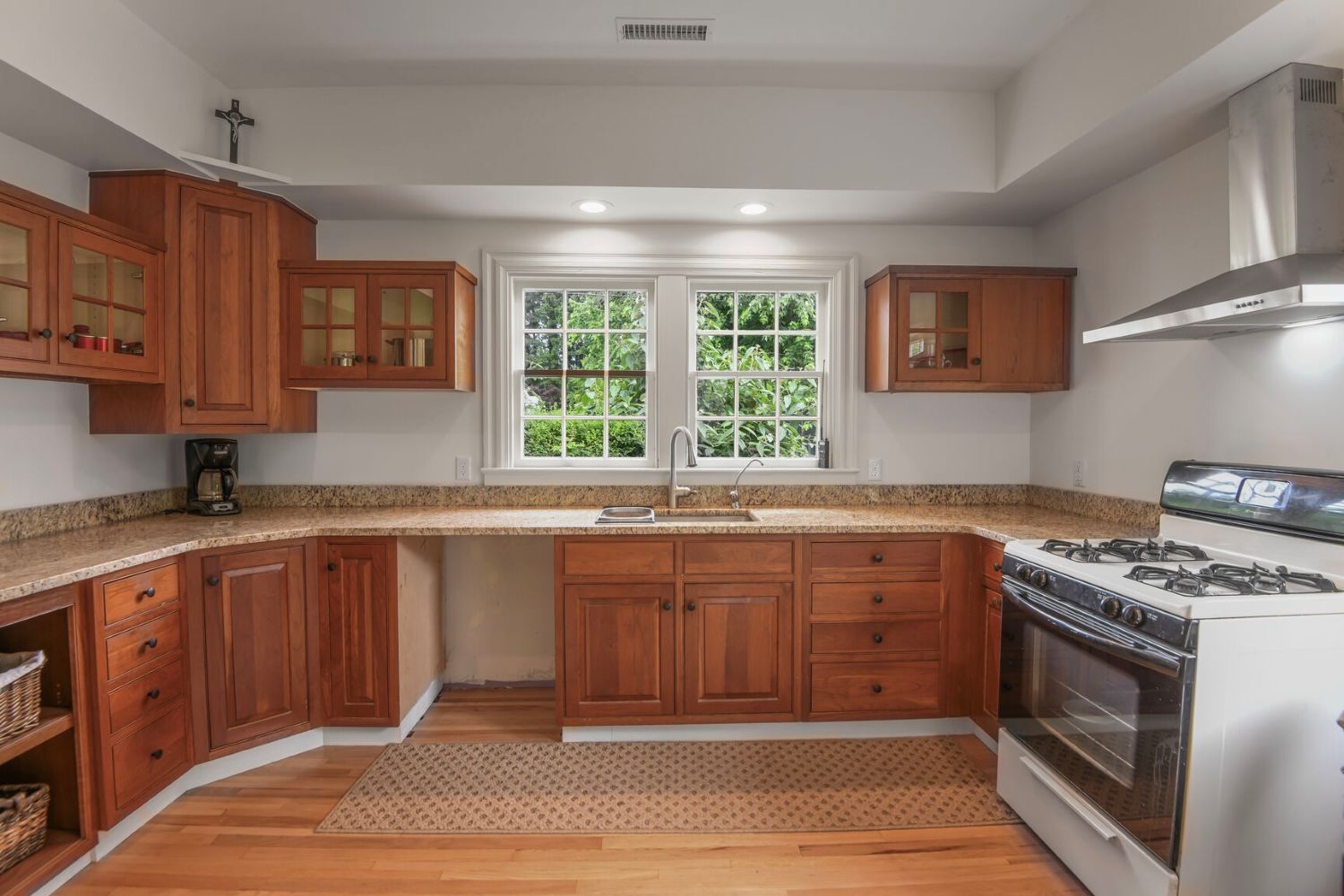 Thoughtfully designed with cherry cabinets and granite countertops, the kitchen opens to lush side yard views.