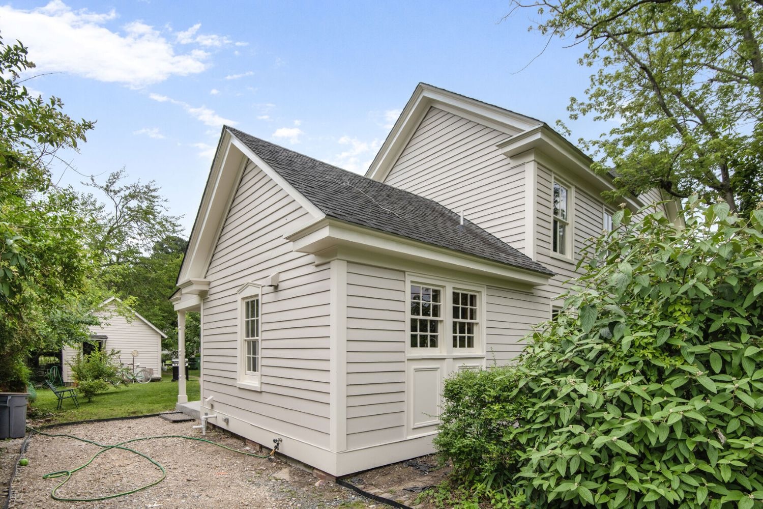 A versatile outbuilding complements the detail-rich rear elevation, including stylish window panels and skirt boards.