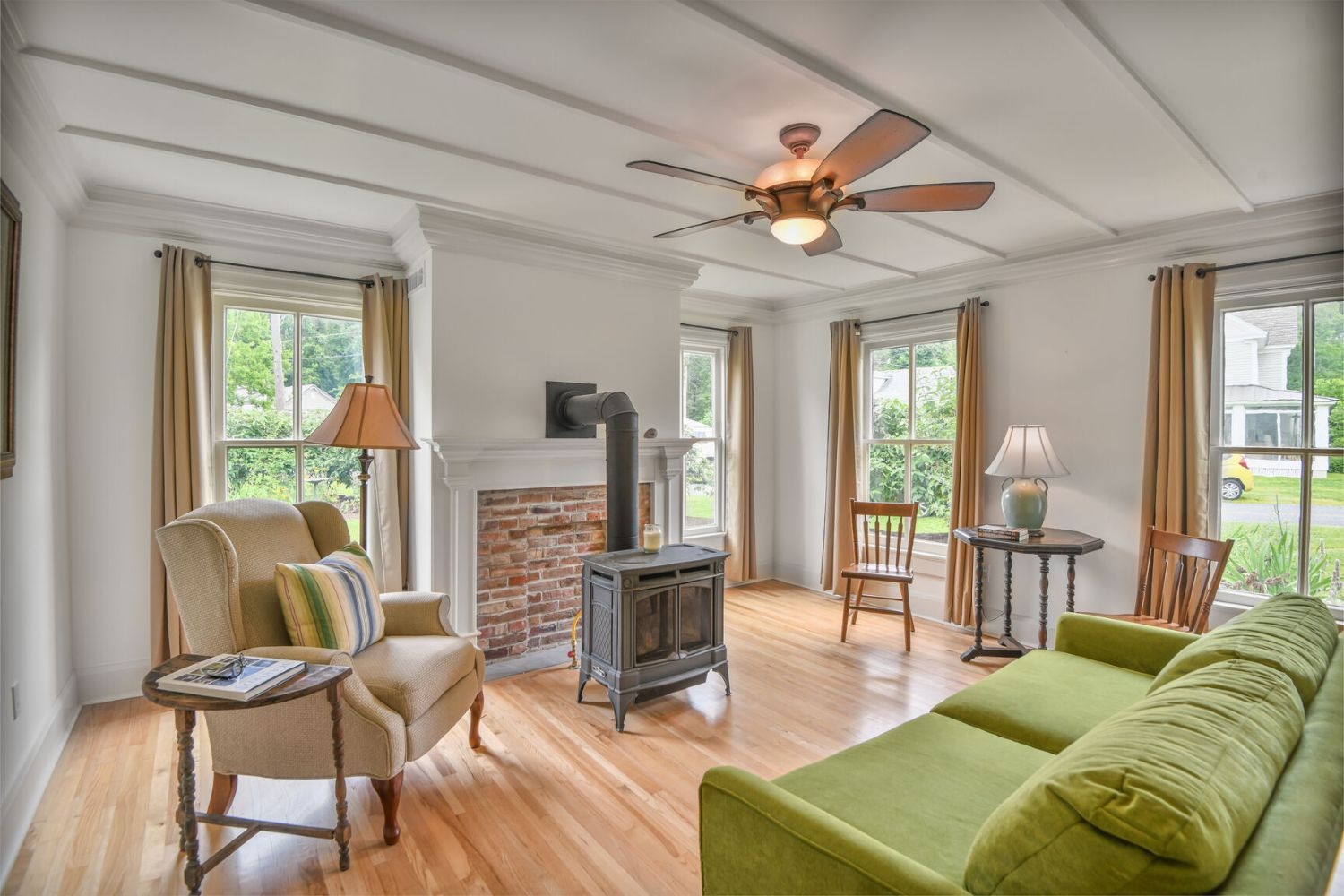 Tall windows infuse the living room with light, while the gas stove brings warmth to crisp autumn evenings.